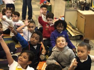 Kindergarten Students raising their hands