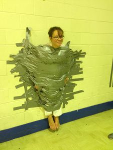 Mrs. Gomez taped to a wall