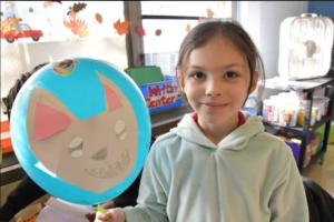 2nd Grader Emma with her Wolf Balloon